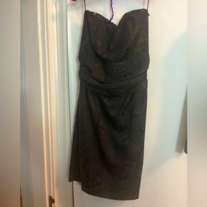 Strapless black dress with sequin accent at neck and matching bolero jacket.